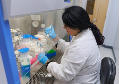 A technician prepares to plate cancer cells in specialized flasks with specialized medium at Shuttle Pharma Laboratories.